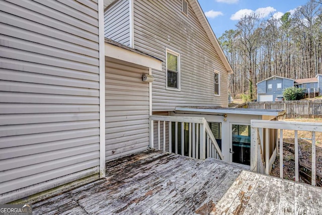 wooden terrace featuring fence