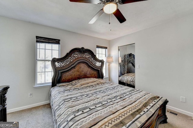 bedroom with a ceiling fan, visible vents, baseboards, and carpet floors