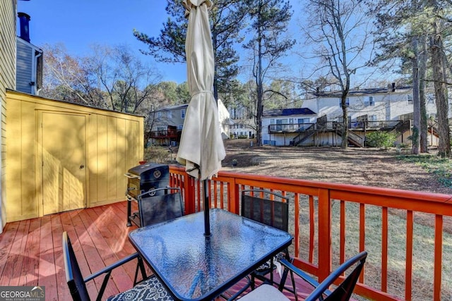 wooden terrace featuring outdoor dining area