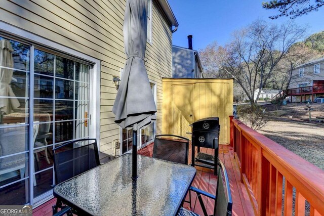 wooden terrace with outdoor dining area