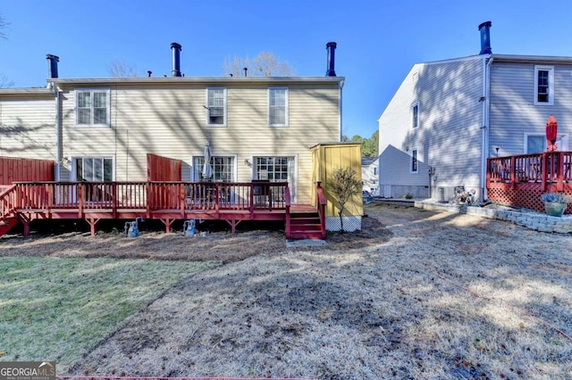 back of house featuring a deck