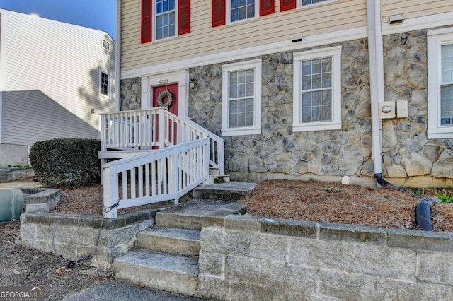 entrance to property featuring stone siding