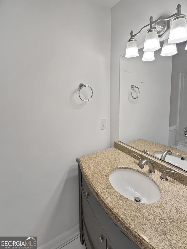 bathroom with vanity and baseboards