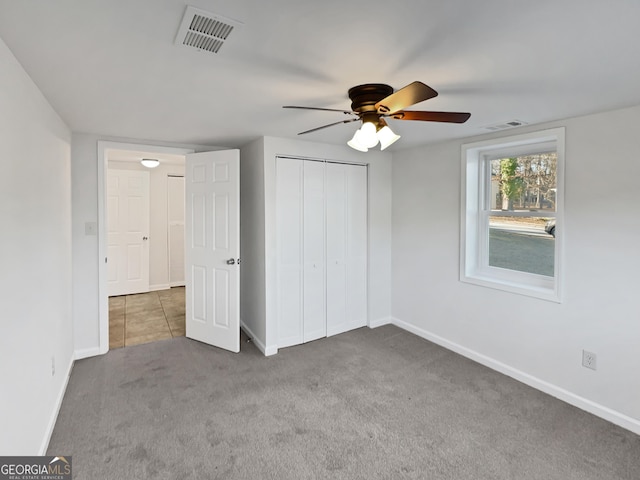 unfurnished bedroom featuring visible vents, baseboards, a closet, and carpet flooring