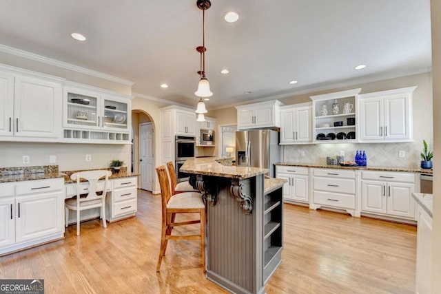 kitchen featuring open shelves, stainless steel appliances, arched walkways, and white cabinets