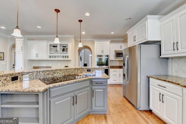 kitchen featuring gray cabinets, open shelves, white cabinetry, arched walkways, and appliances with stainless steel finishes