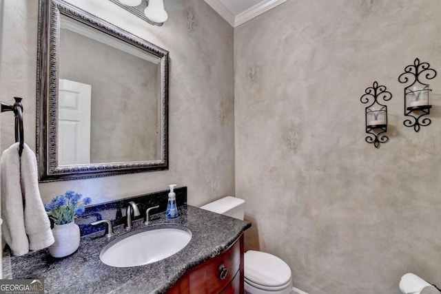 half bathroom with vanity, toilet, and crown molding