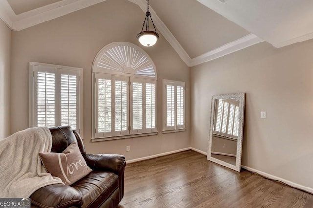 sitting room with baseboards, wood finished floors, ornamental molding, and vaulted ceiling