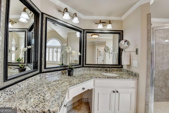 full bath featuring visible vents, crown molding, tile patterned flooring, tiled shower, and vanity