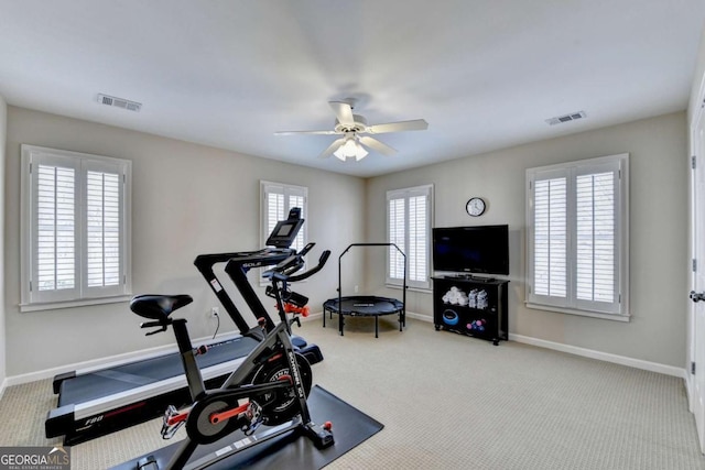 exercise area featuring visible vents, baseboards, a ceiling fan, and carpet flooring