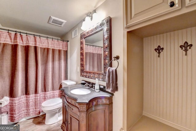 bathroom with visible vents, toilet, and vanity