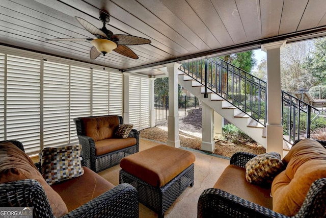 sunroom / solarium featuring wooden ceiling and a ceiling fan