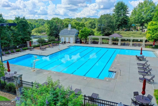 pool featuring a pergola, a patio, and fence