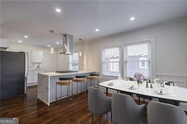 kitchen with ornamental molding, range hood, stainless steel appliances, white cabinetry, and dark wood-style flooring