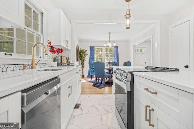 kitchen with decorative light fixtures, stainless steel appliances, marble finish floor, white cabinetry, and a sink