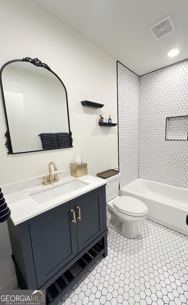 bathroom featuring tile patterned flooring, visible vents, toilet, and vanity