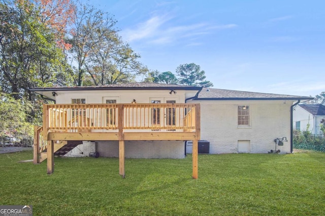 rear view of property featuring a deck, central AC, a yard, brick siding, and stairs