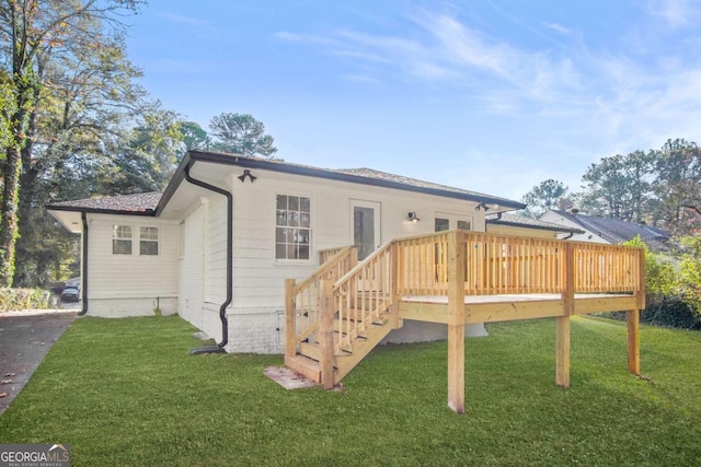 back of property featuring a yard and a wooden deck