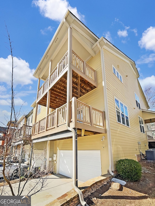 view of side of home featuring an attached garage