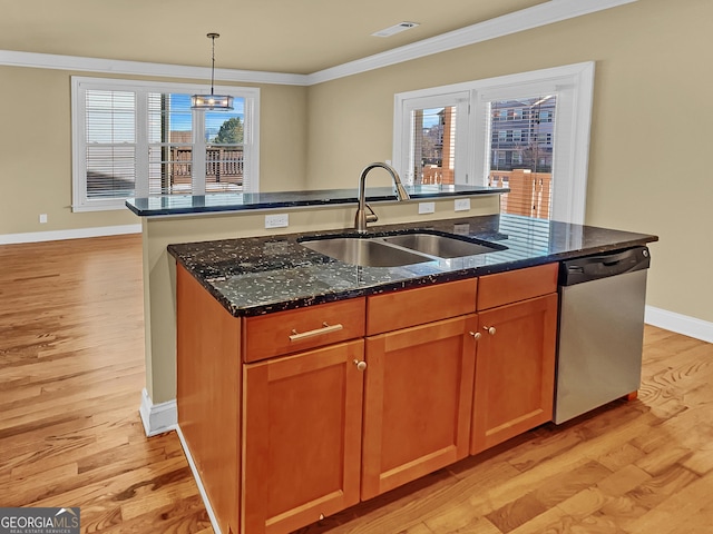 kitchen with a kitchen island with sink, ornamental molding, a sink, light wood-style floors, and stainless steel dishwasher