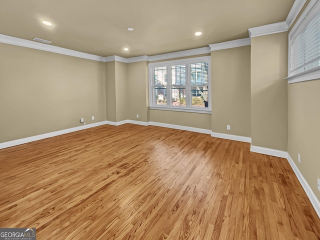 empty room with recessed lighting, baseboards, light wood finished floors, and ornamental molding