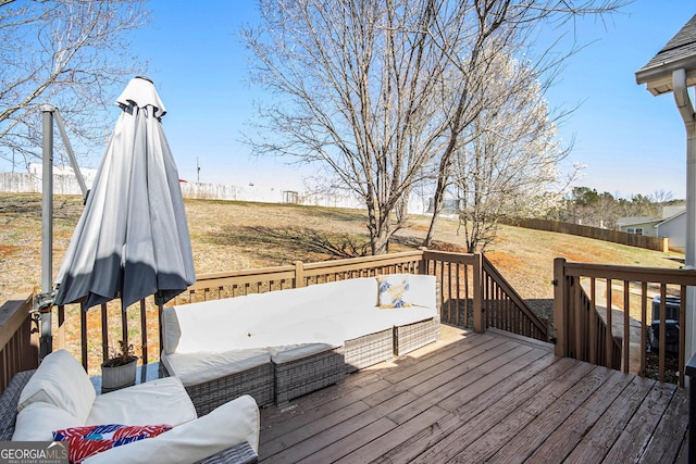 wooden deck with outdoor lounge area and fence