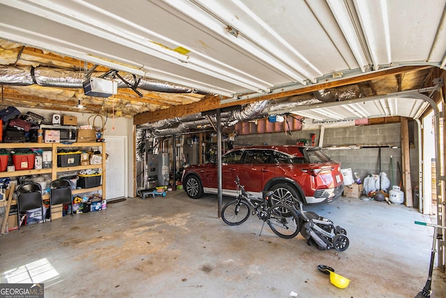 garage featuring a garage door opener and water heater