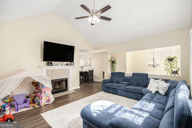 living area with ceiling fan with notable chandelier, wood finished floors, a fireplace, and baseboards