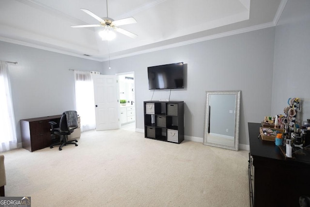 home office with crown molding, ceiling fan, baseboards, a tray ceiling, and carpet floors