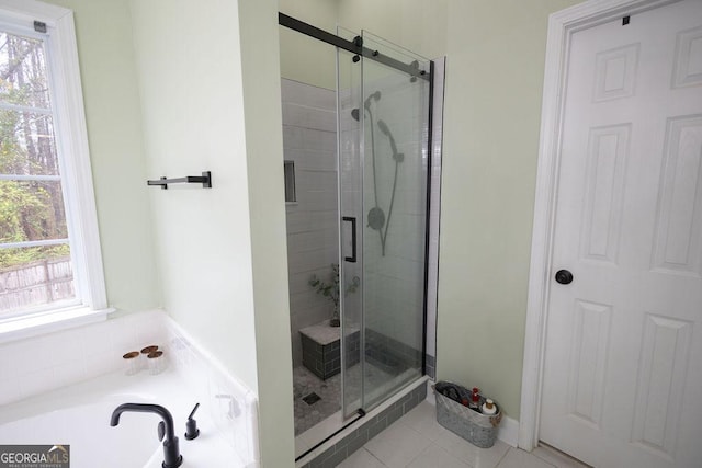 bathroom featuring tile patterned floors, a garden tub, and a shower stall