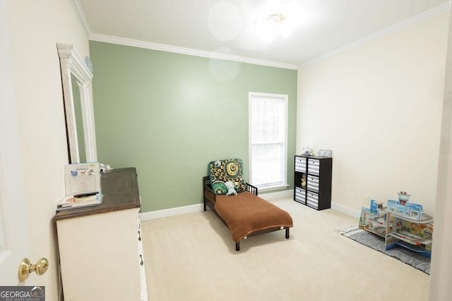 sitting room with carpet flooring, crown molding, and baseboards