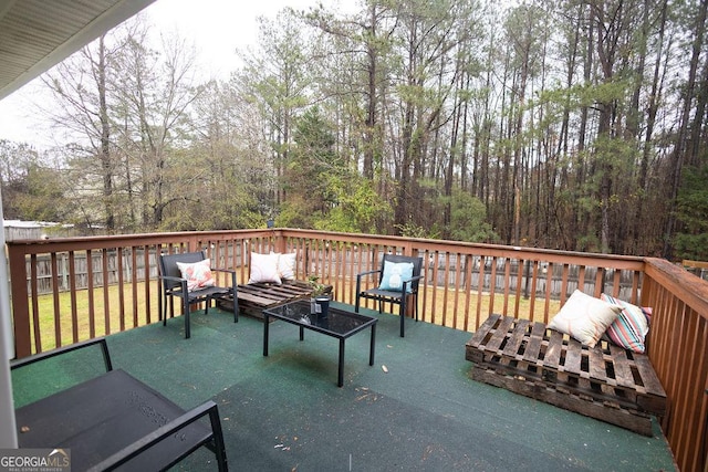 wooden terrace with an outdoor hangout area