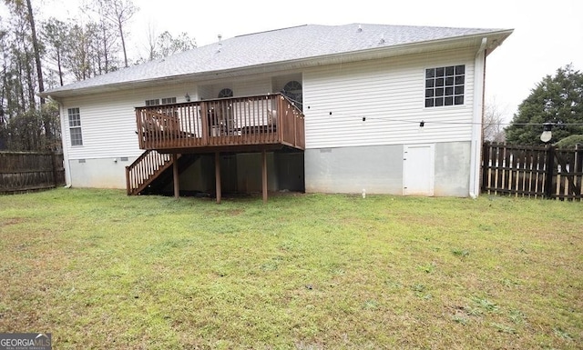 back of property with a yard, fence, and crawl space