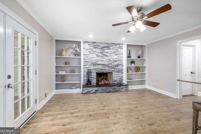 unfurnished living room featuring a fireplace, crown molding, and wood finished floors