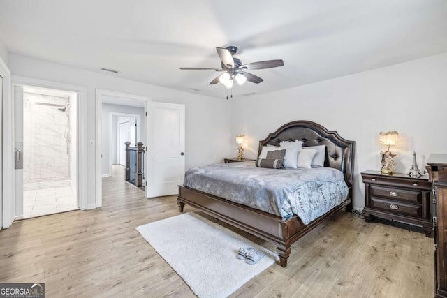 bedroom with visible vents, light wood-type flooring, and a ceiling fan