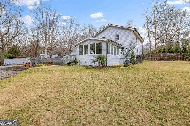 exterior space featuring fence and a lawn