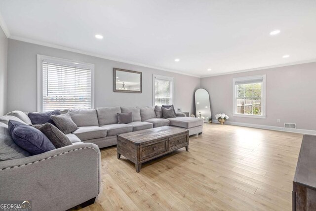 living area with visible vents, plenty of natural light, and light wood-type flooring