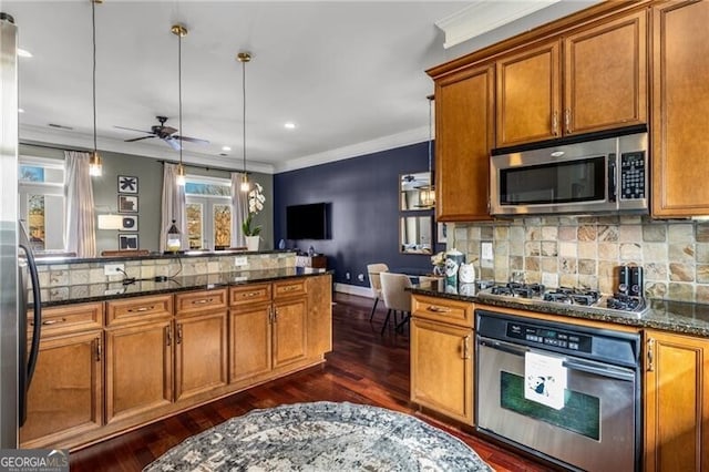 kitchen with decorative backsplash, brown cabinets, stainless steel appliances, and crown molding