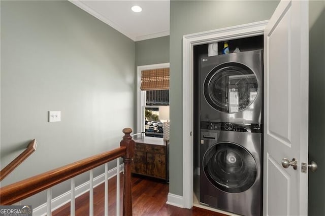 clothes washing area featuring laundry area, recessed lighting, dark wood-type flooring, crown molding, and stacked washer / dryer