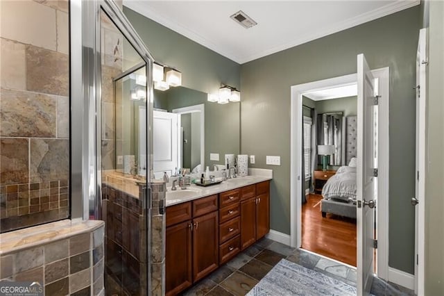 ensuite bathroom featuring visible vents, a stall shower, ornamental molding, a sink, and double vanity