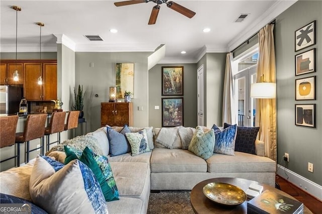 living room featuring recessed lighting, visible vents, baseboards, and crown molding