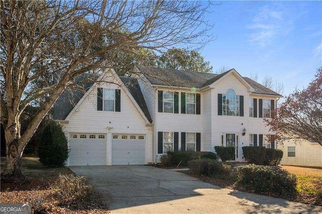 colonial house with driveway and a garage