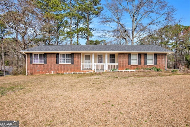 ranch-style home with crawl space, brick siding, roof with shingles, and a front yard