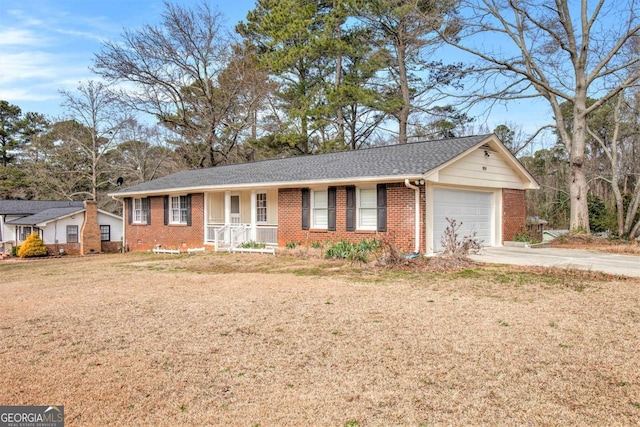 ranch-style home with driveway, a front yard, a shingled roof, a garage, and brick siding