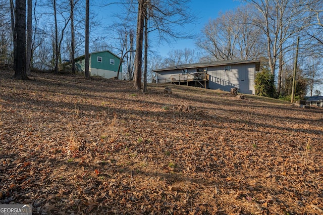 view of yard featuring a wooden deck