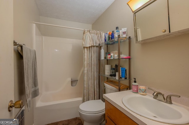 full bathroom featuring vanity, toilet, shower / tub combo with curtain, and a textured ceiling