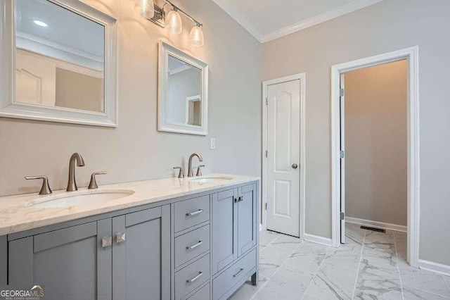 bathroom featuring a sink, baseboards, marble finish floor, and crown molding