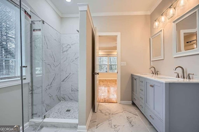 full bathroom featuring a sink, marble finish floor, a shower stall, and crown molding