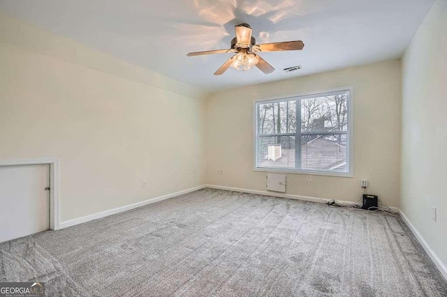 spare room featuring visible vents, ceiling fan, baseboards, and carpet