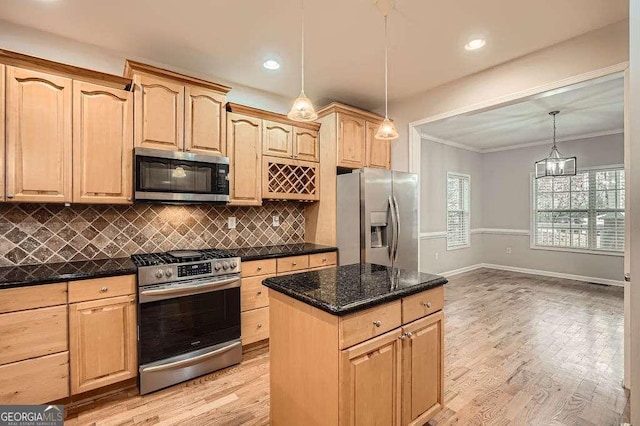 kitchen with light brown cabinetry, backsplash, appliances with stainless steel finishes, and light wood-style floors